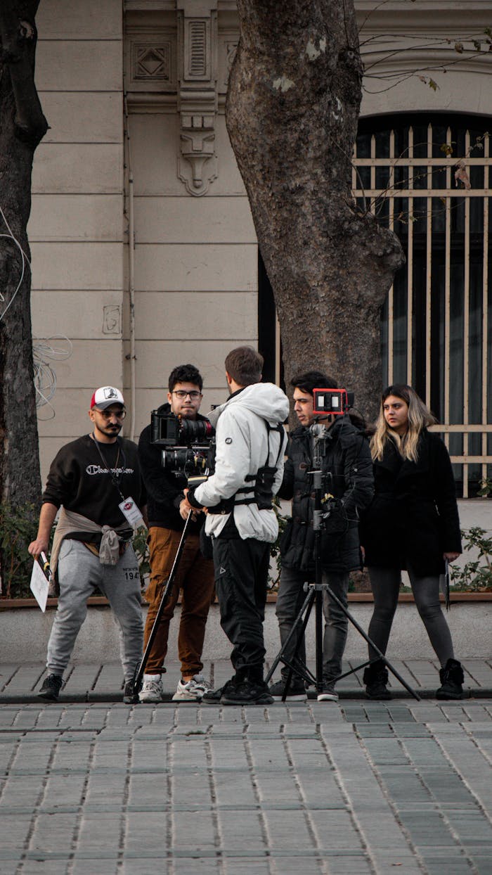 A group of filmmakers setting up equipment on a street in Istanbul, capturing a scene.